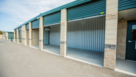 Exterior storage units with their doors rolled up at the Towne Storage Colt Plaza Storage Facility
