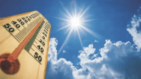 Temperature gage and view of sky with sunlight